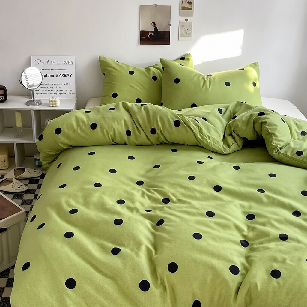 Green bedding set with black polka dots in a bright bedroom