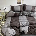 Brown and grey colorblock bedding set on a bed with matching pillowcases