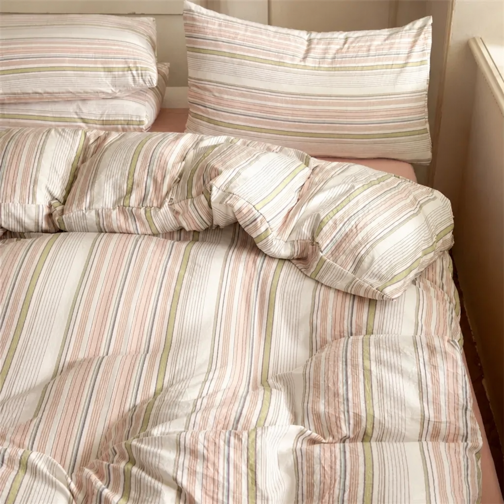 Striped bedding set on a bed with pillows