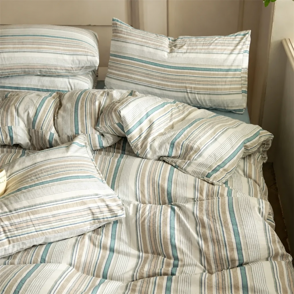 Blue and tan striped cotton bedding set on a bed