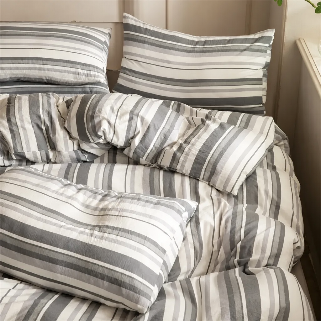 Striped bedding set on a bed with pillows