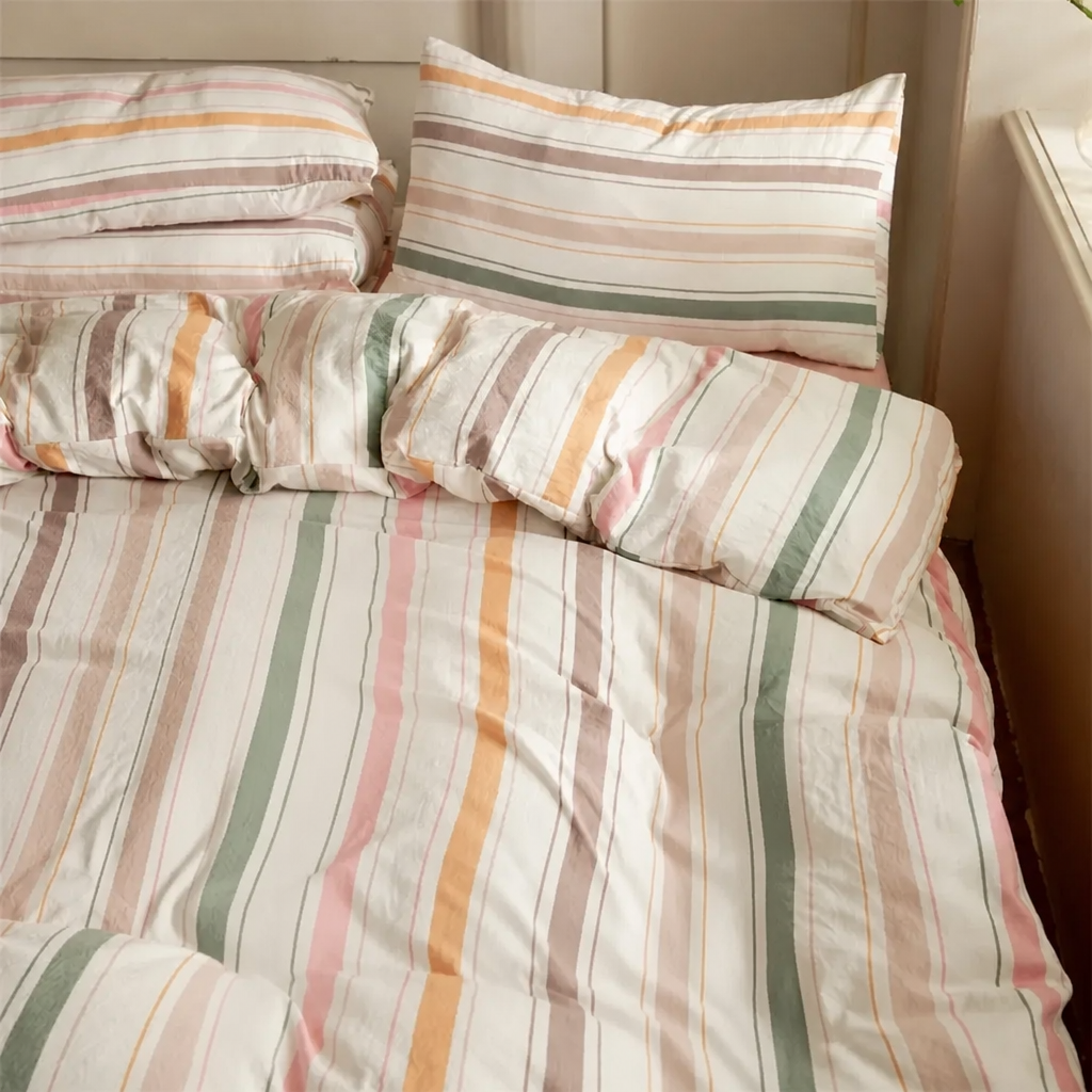 Striped bedding set on a bed with pillows
