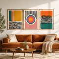 Three abstract canvas prints in mustard, orange, teal and pink with bold line art details