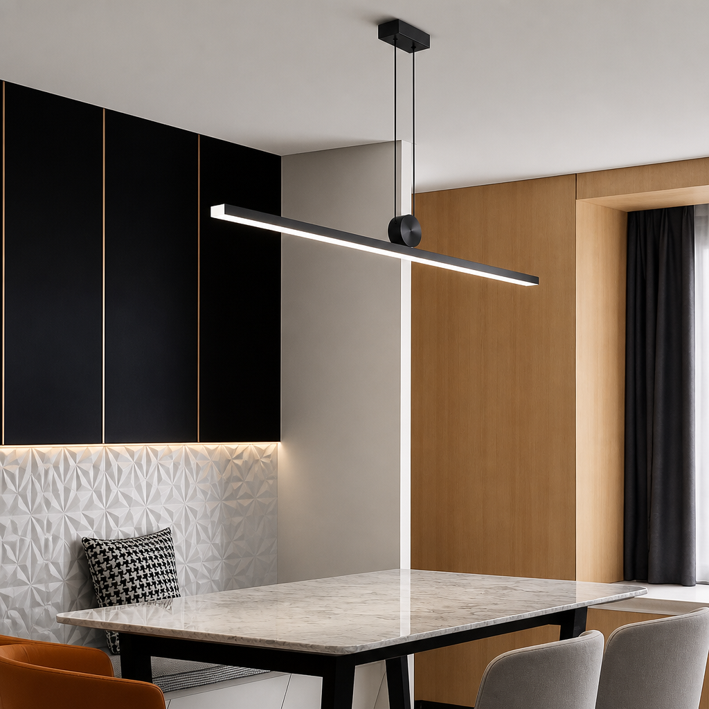 A modern linear LED pendant light with a matte black finish and a warm white glow, suspended over a dining table in a contemporary interior setting.