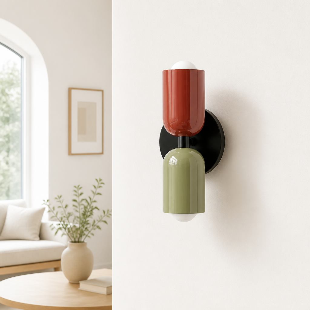 Red and green two-tone wall sconce on black backplate