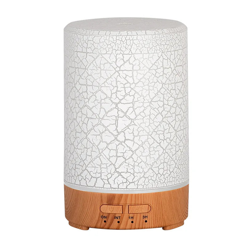 Minimalist USB essential oil diffuser with white cracked glaze finish and light wood grain base.