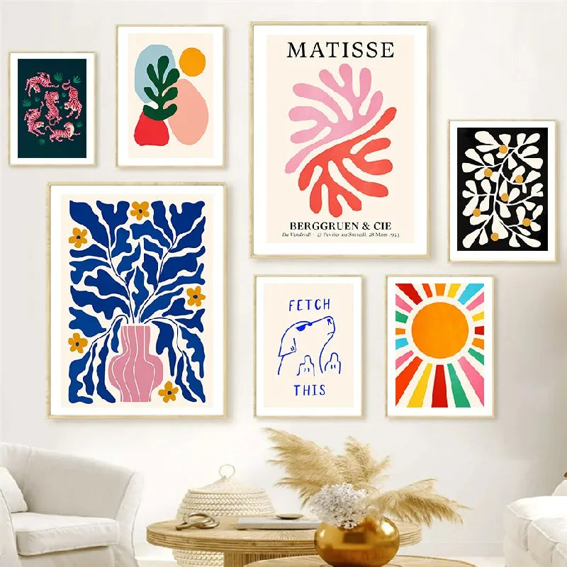 Collection of colourful art prints on a wall in a living room setting.