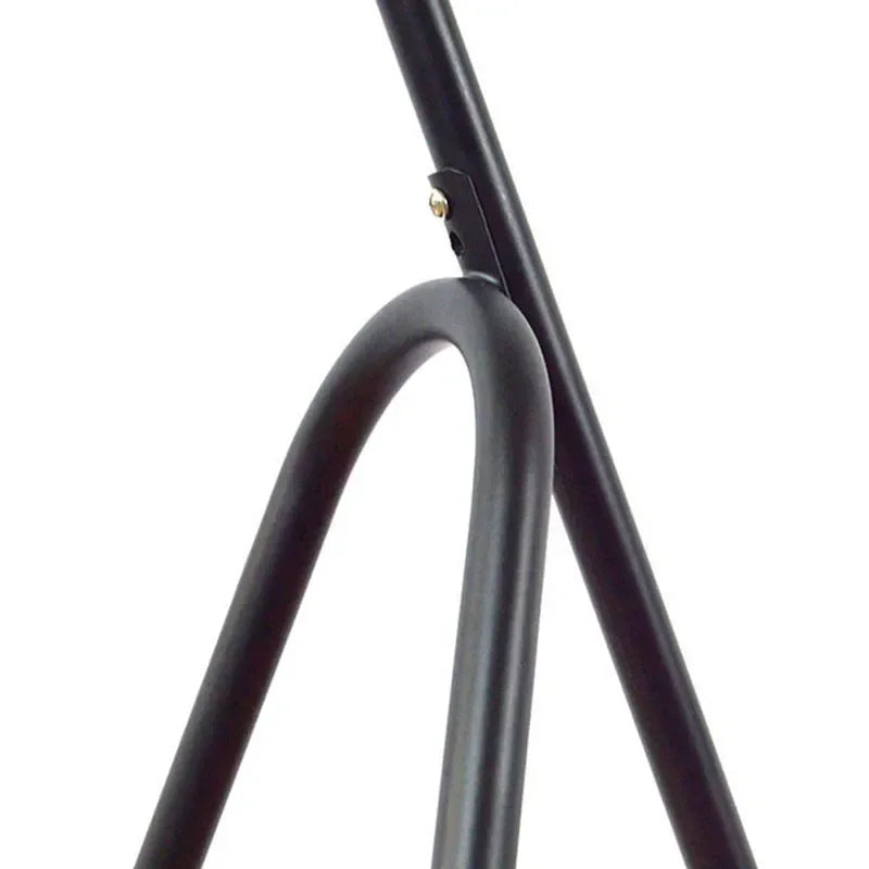 Close-up of black tripod floor lamp shade frame fitting.
