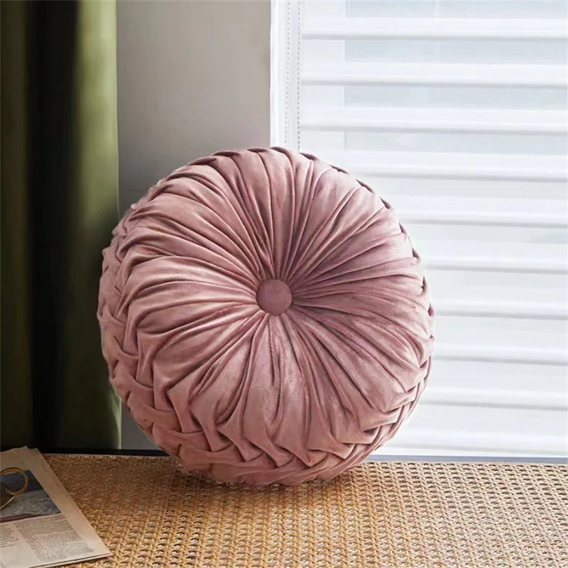 Round pink cu on a textured surface with a window in the backgroundhion
