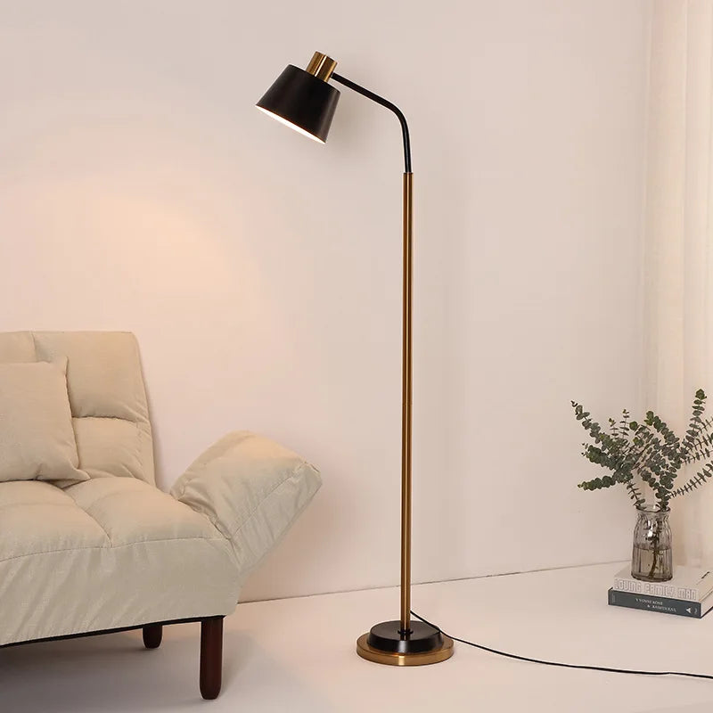Black arc floor lamp beside a cream sofa in a bright living room
