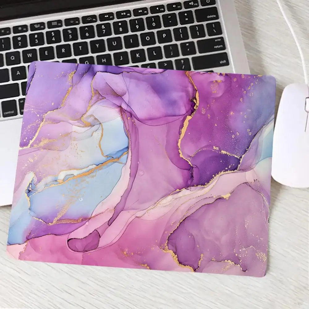Laptop with a purple and gold abstract design on a desk