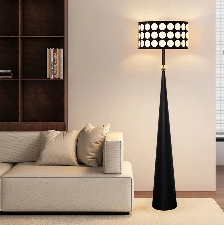 Modern living room with a black floor lamp and a bookshelf.