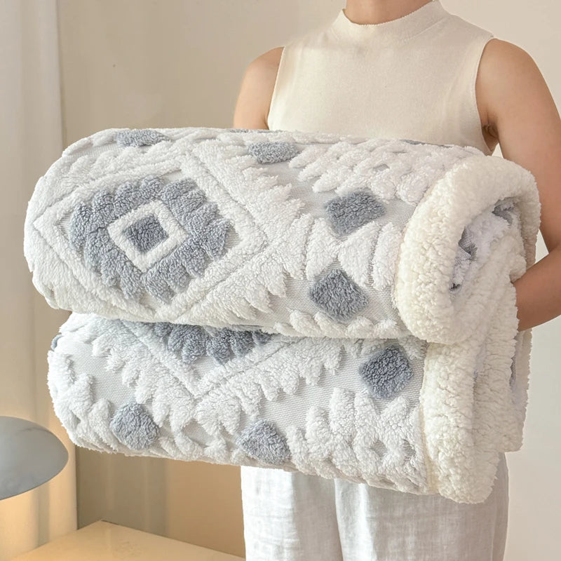 Person holding a white and silver grey patterned blanket