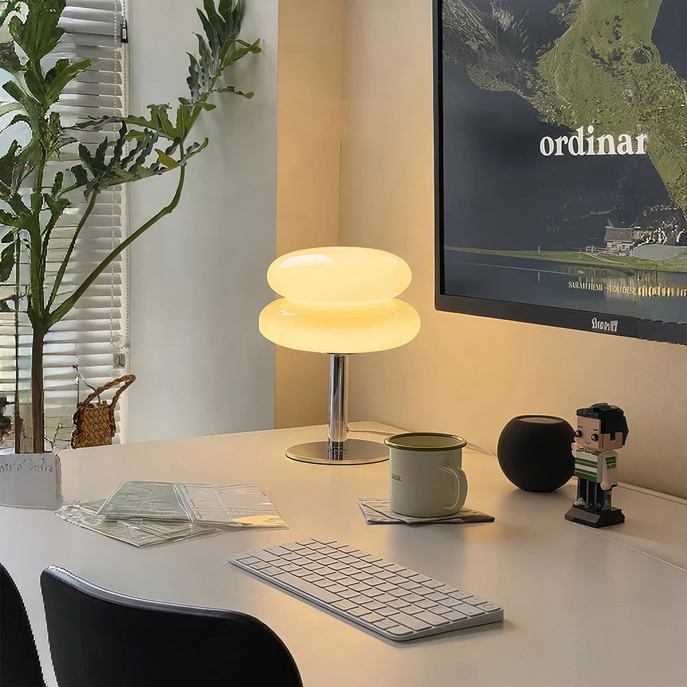 Modern office desk setup with a neutral-glow lamp.
