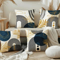 Decorative pillows with geometric patterns on a couch in a living room setting.