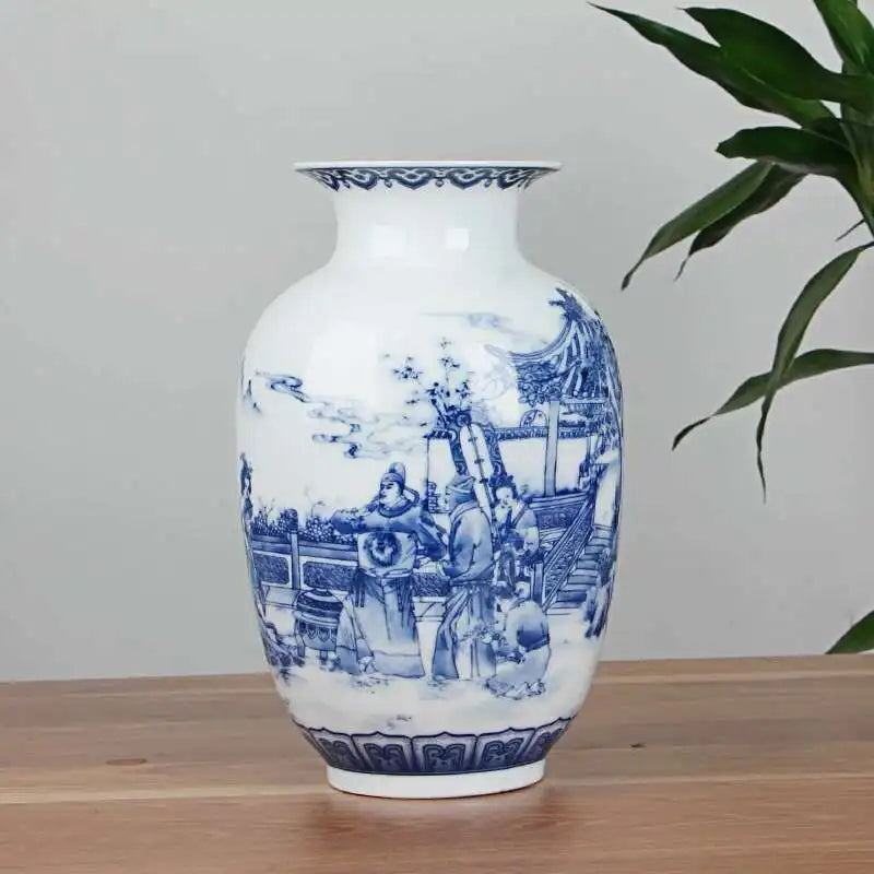 White vase with blue intricate patterns on a wooden surface with a plant in the background
