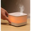 Humidifier emitting steam on a wooden surface with a blurred background