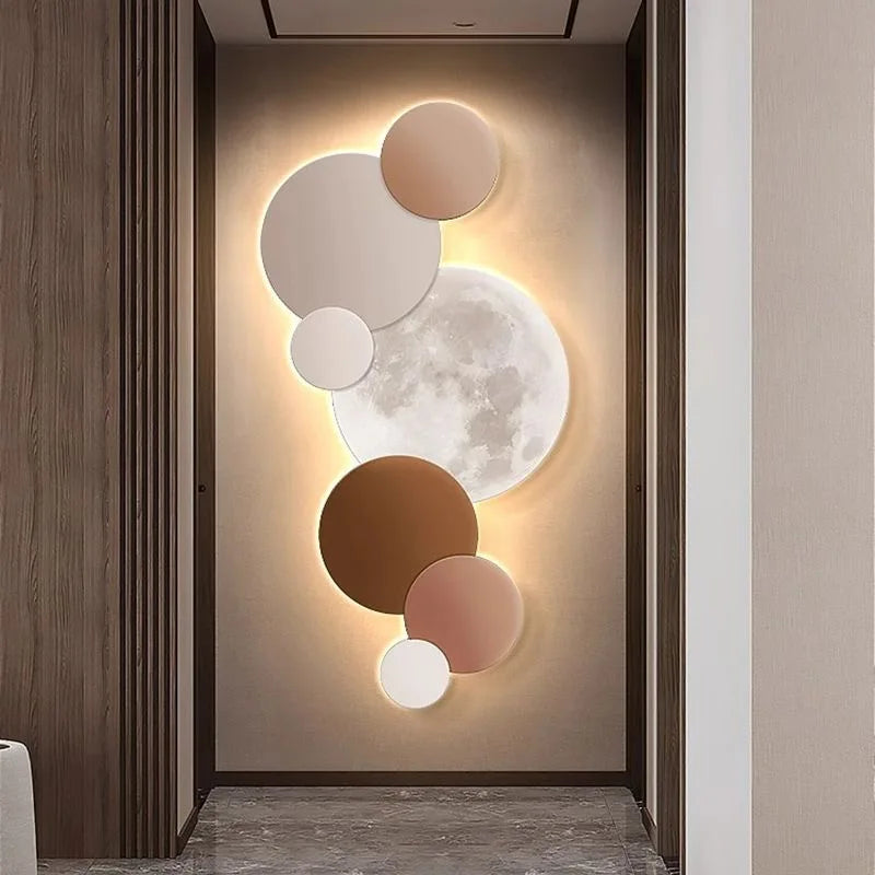Warm beige and brown moon wall light glowing above a console table