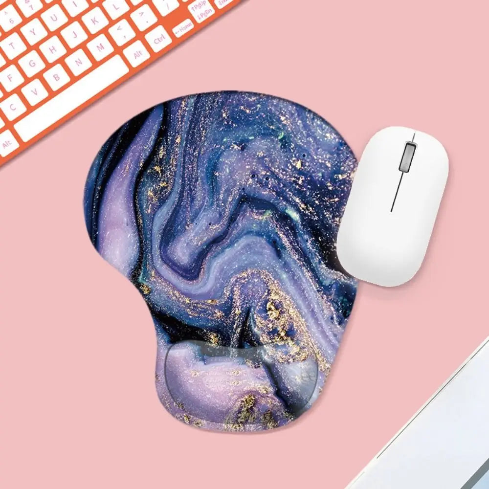 Mouse pad with marble design on a pink surface with a keyboard and mouse.