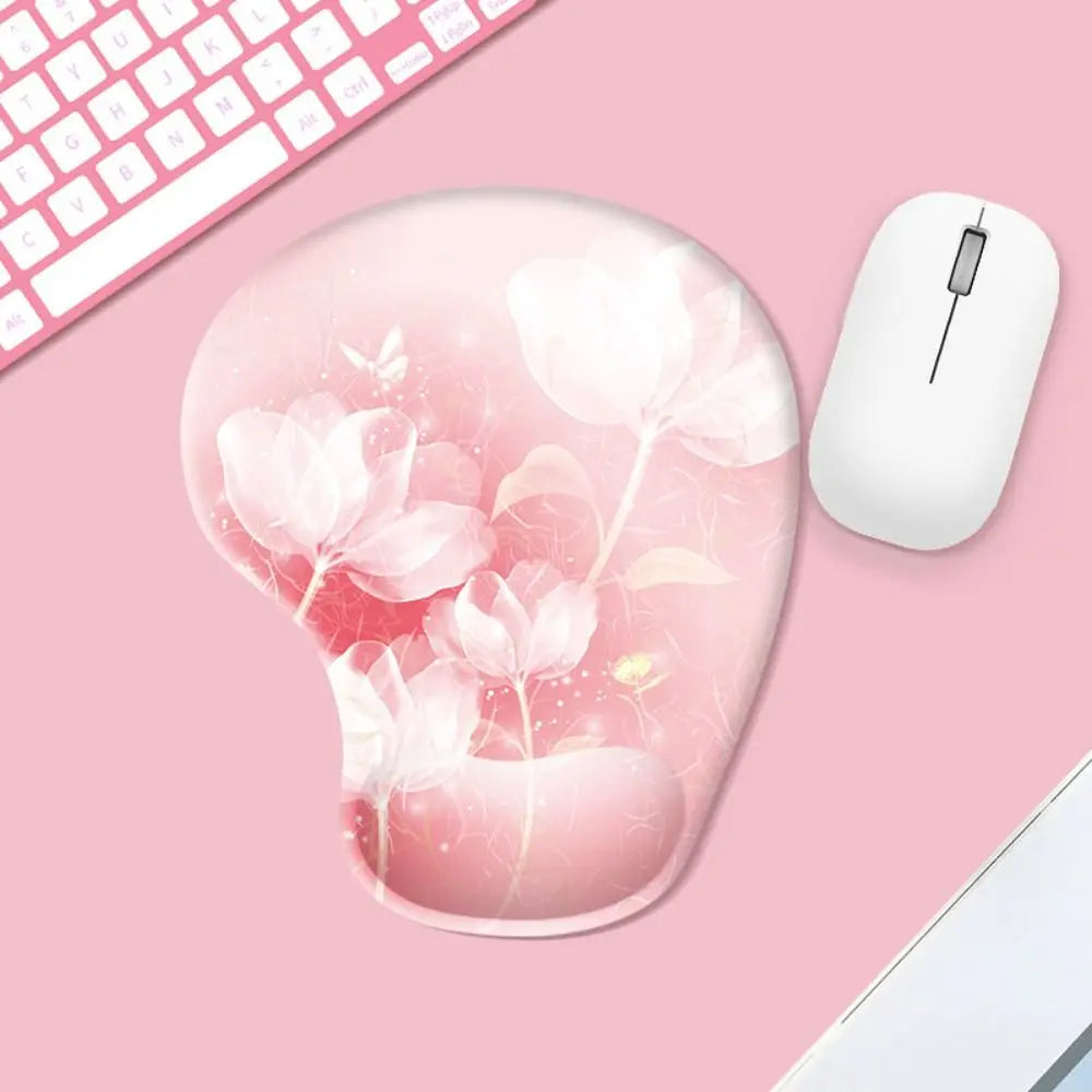 Mouse pad with floral design on a pink surface with a mouse and keyboard.