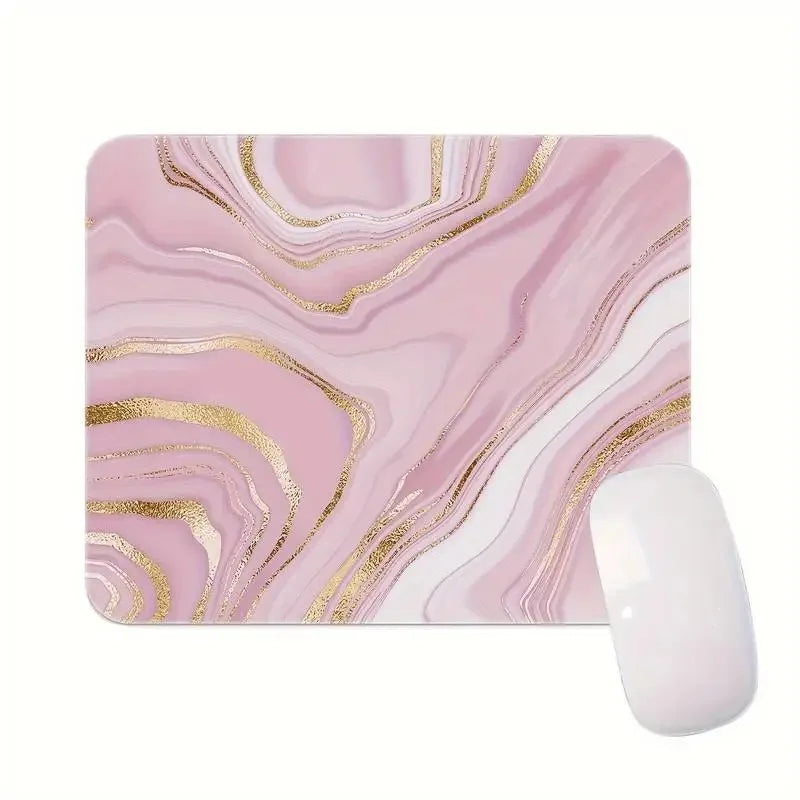 Pink marble mouse pad with gold accents and a white computer mouse on a white background