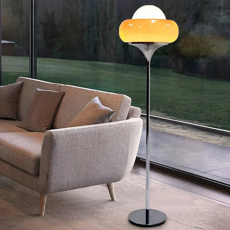 Modern floor lamp with a yellow glass shade.