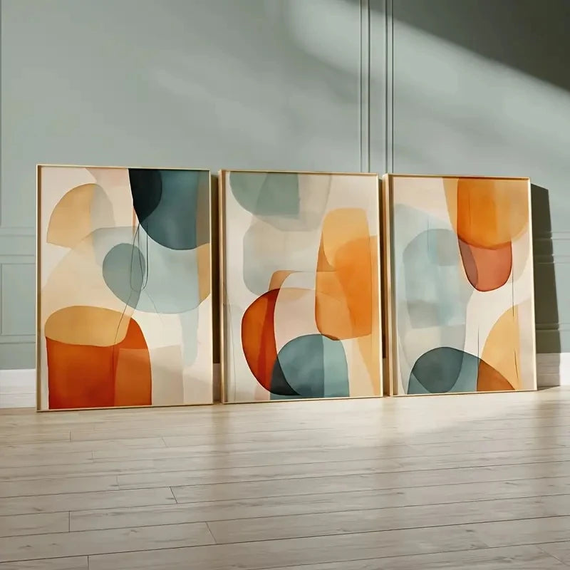 Three abstract art pieces in a modern interior setting