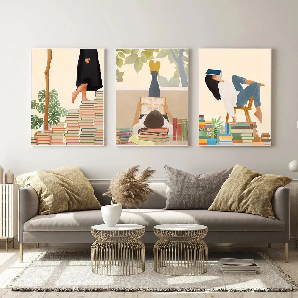Living room with a grey sofa, decorative pillows, and wall art depicting people reading books.