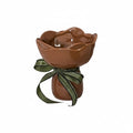 Brown flower-shaped pot with green ribbon on a white background