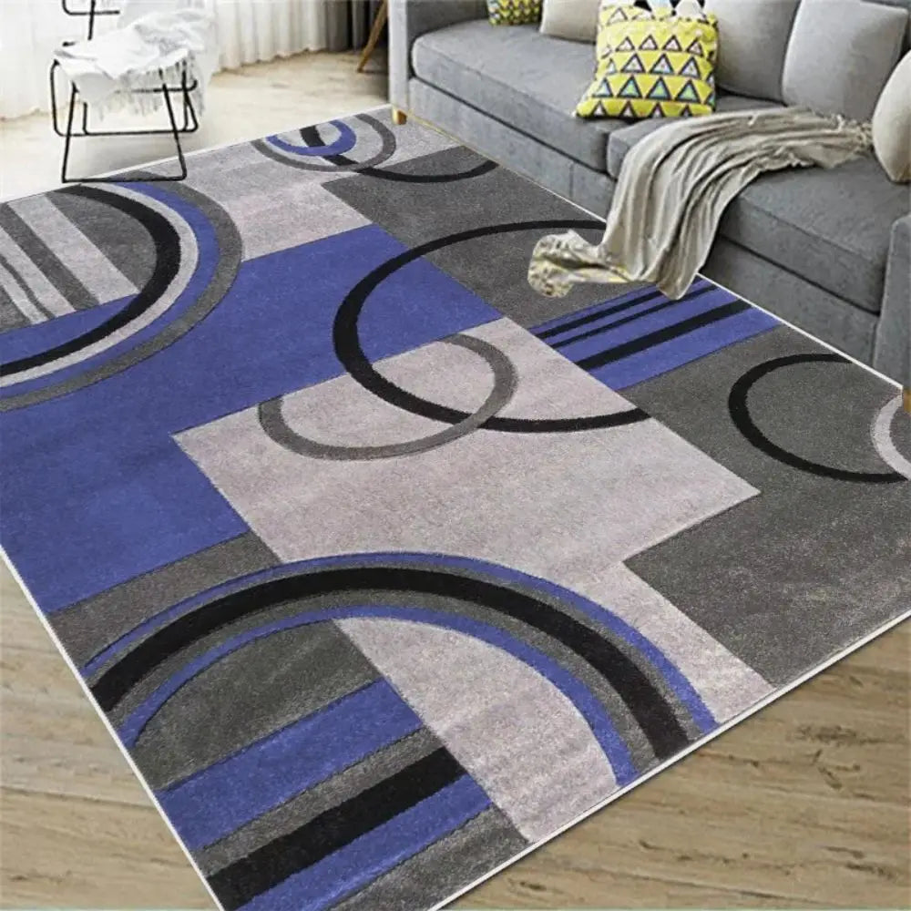 Blue, grey, and black Nordic geometric rug with curved arc patterns in a living room.