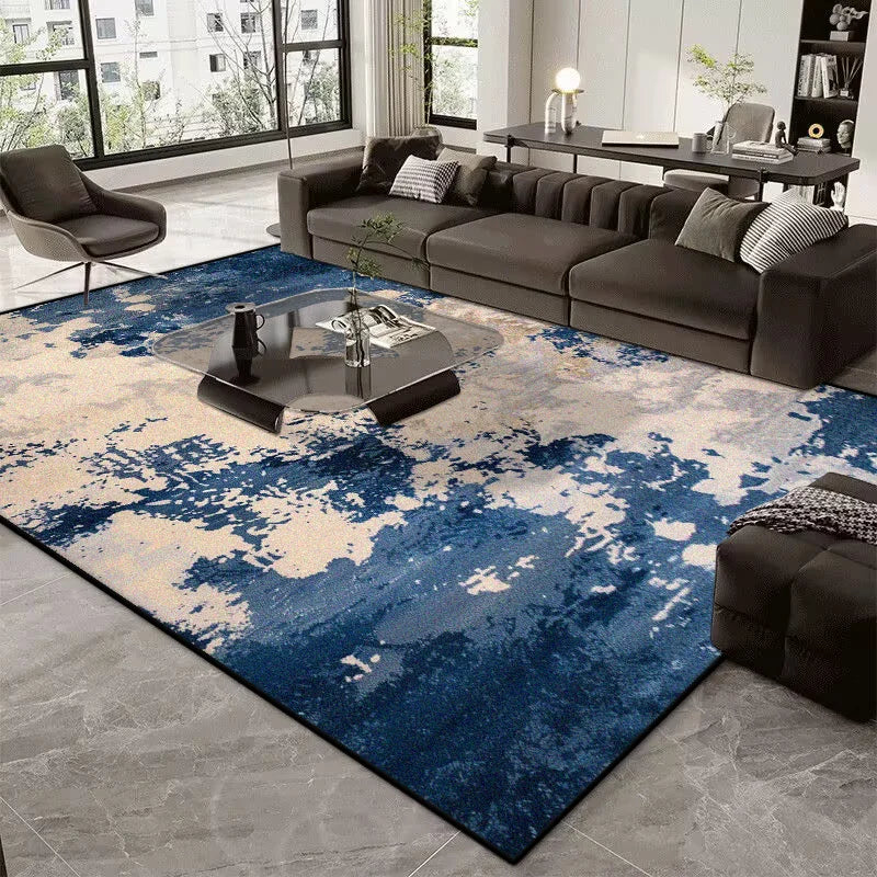 Modern living room with a blue and gray abstract rug, dark sofa, and coffee table.