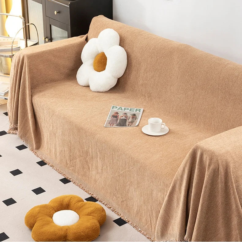 Sandstone orange herringbone chenille sofa throw with fringe detail on a modern couch.