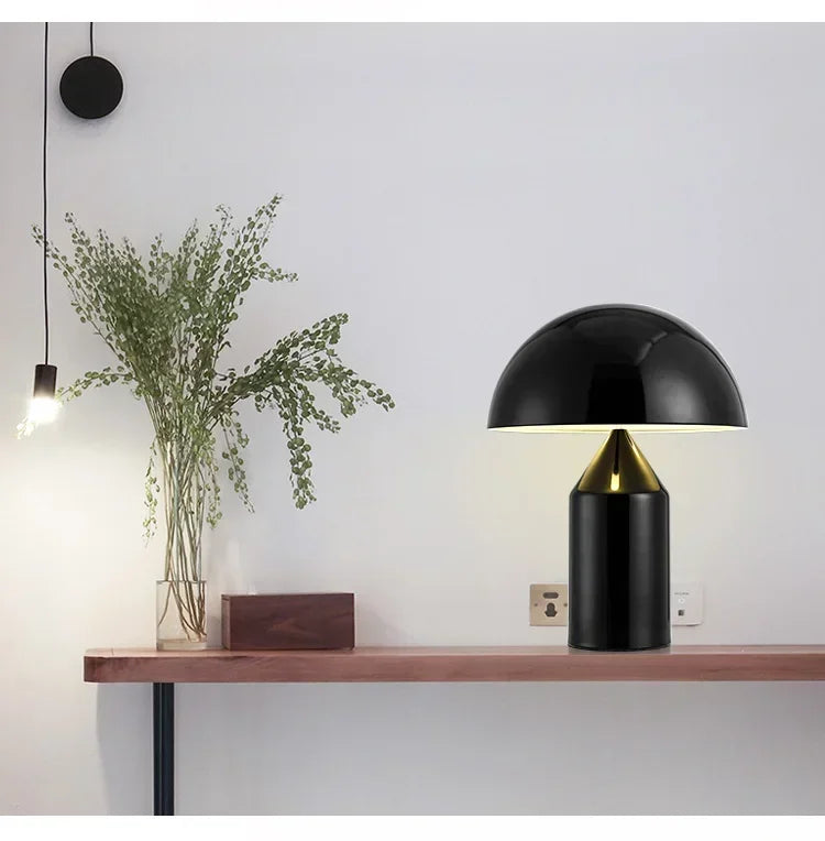 Modern black table lamp on a wooden surface with a minimalistic background