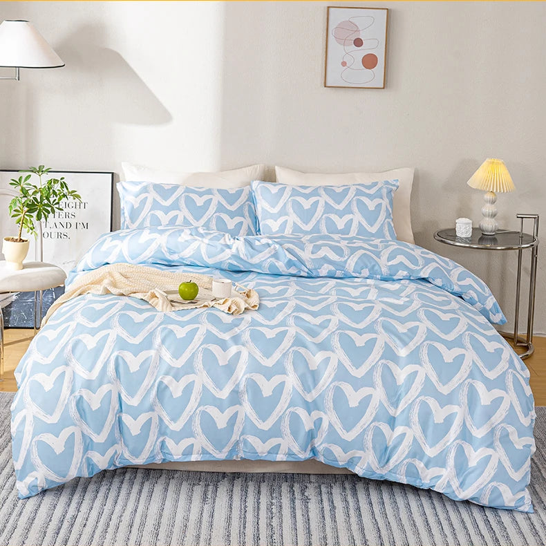 Blue heart-patterned bedding set on a bed in a bedroom.