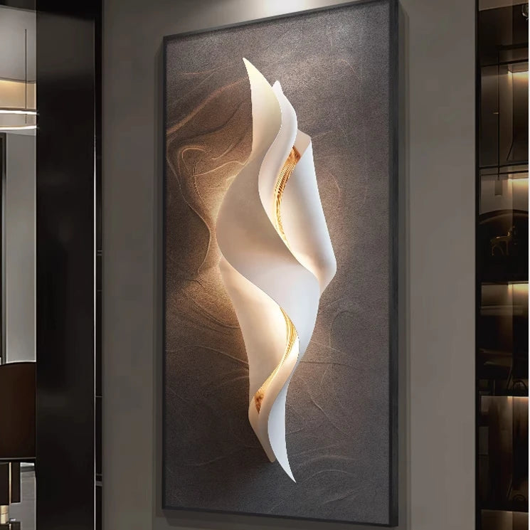 Lumina Flow LED wall art light with compact twisted white ribbon design and warm gold glow on a brown textured canvas