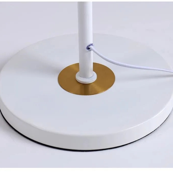 White base detail with brass accent and cable outlet