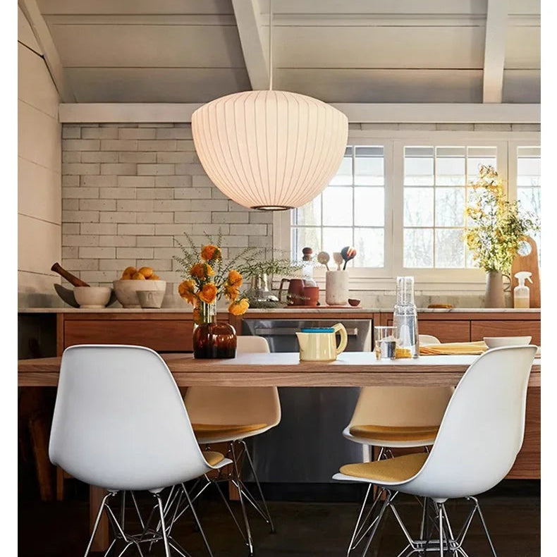 Warm glowing silk pendant lamp in a modern lounge with glass block walls