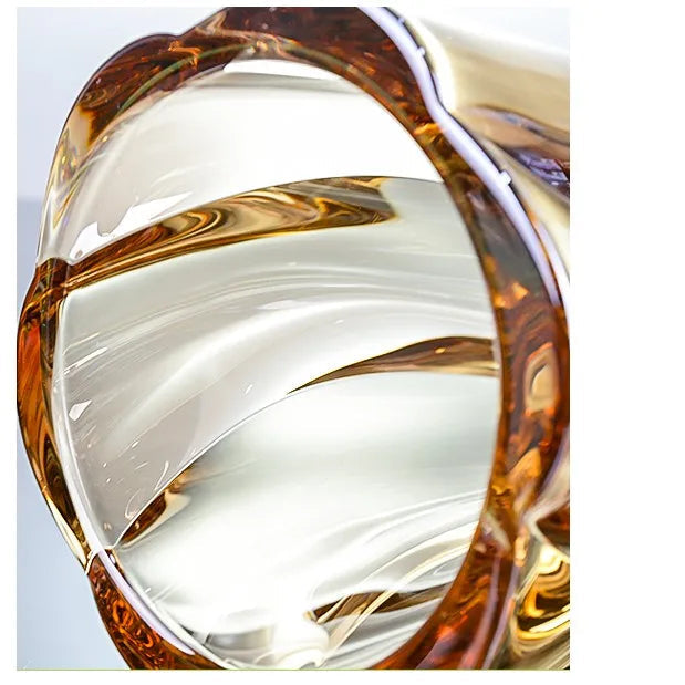 Sunset amber crystal glass vase featuring a rich golden gradient and spiralled texture.