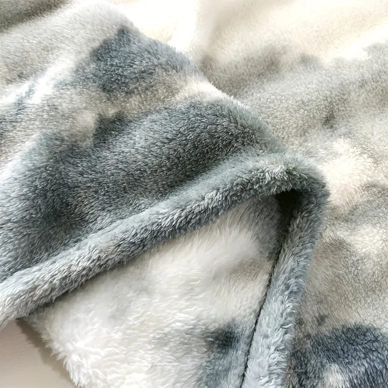 Close-up of a soft, Polyester fabric with a grey and white blanket