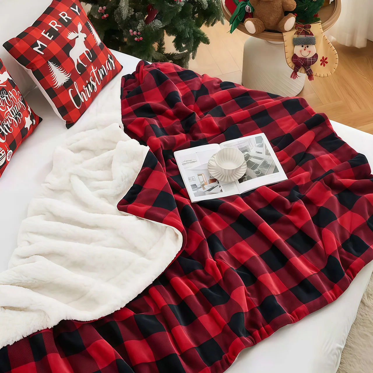 Red and black checkered blanket on a bed with Christmas decor