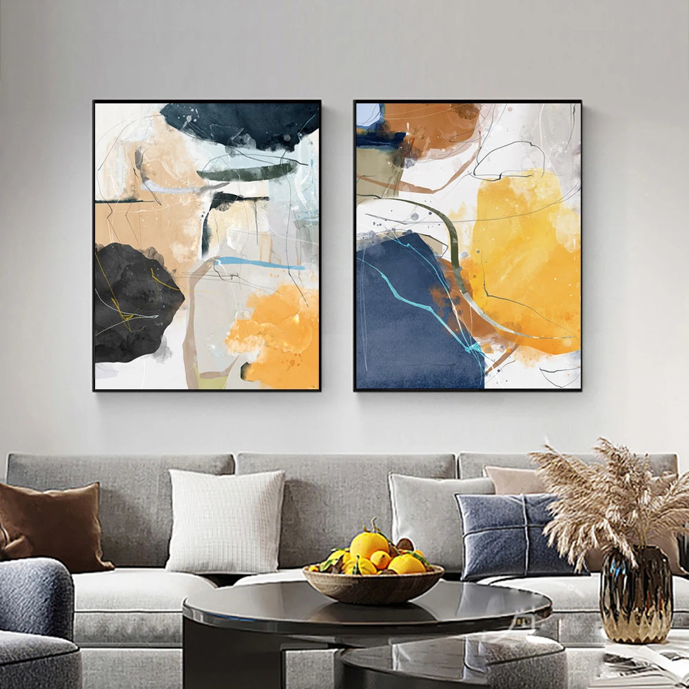 Two abstract art pieces on a wall above a sofa with decorative elements.