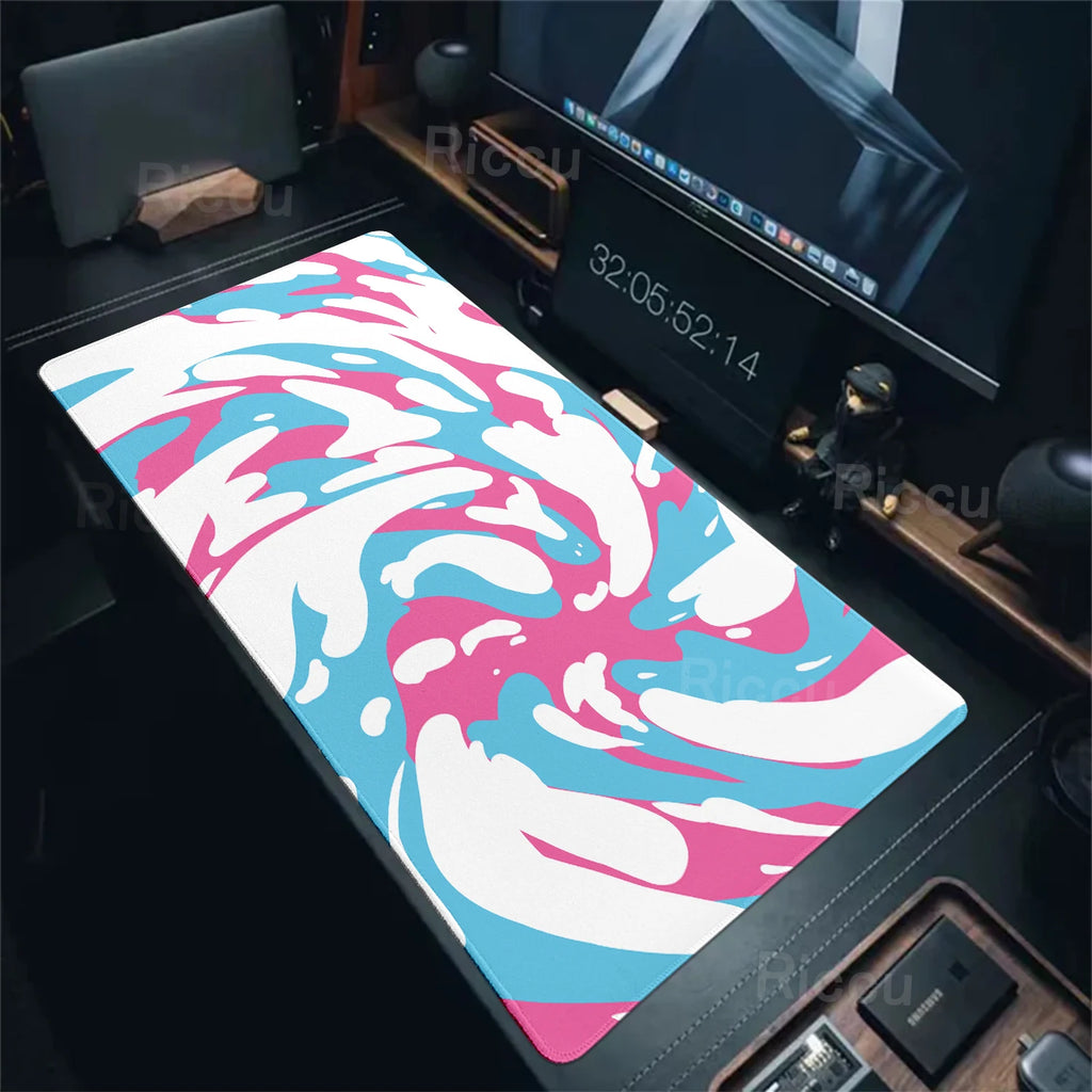 Colorful abstract mouse pad on a desk with computer equipment.