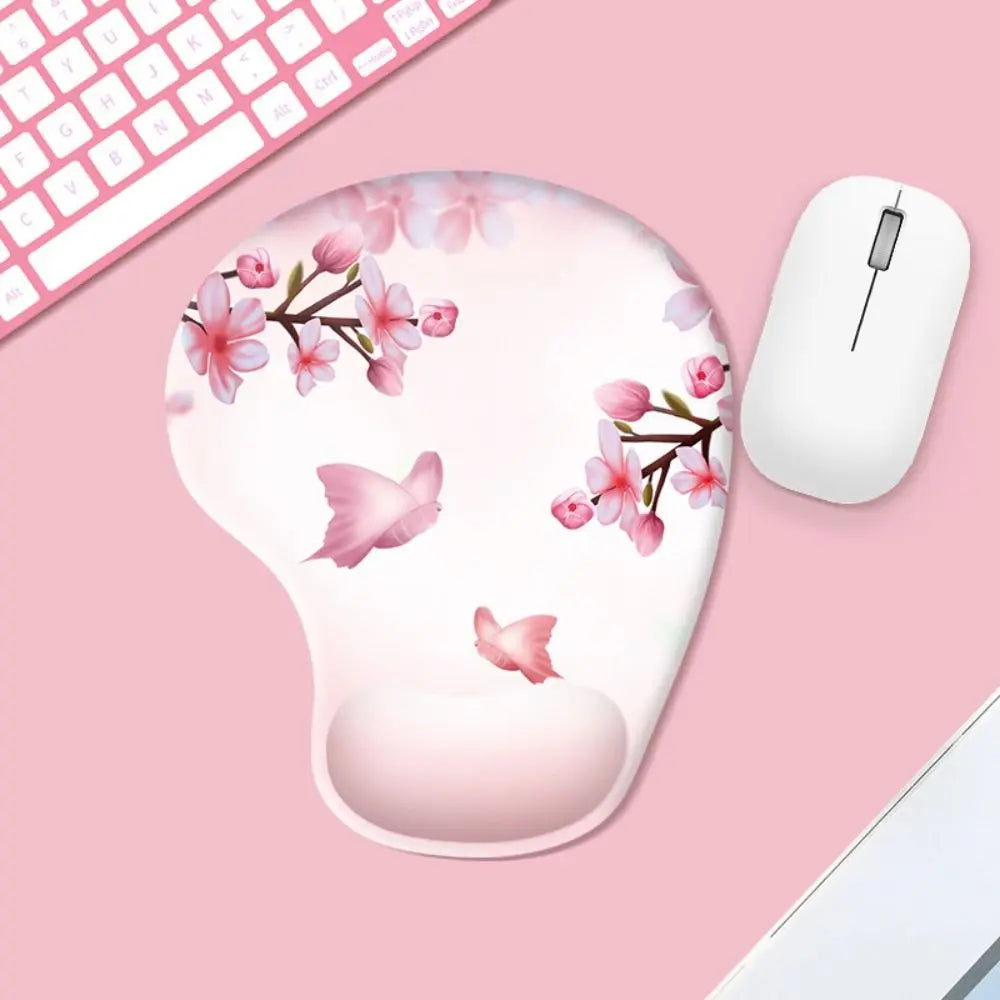 Mouse pad with floral design and mouse on a pink surface