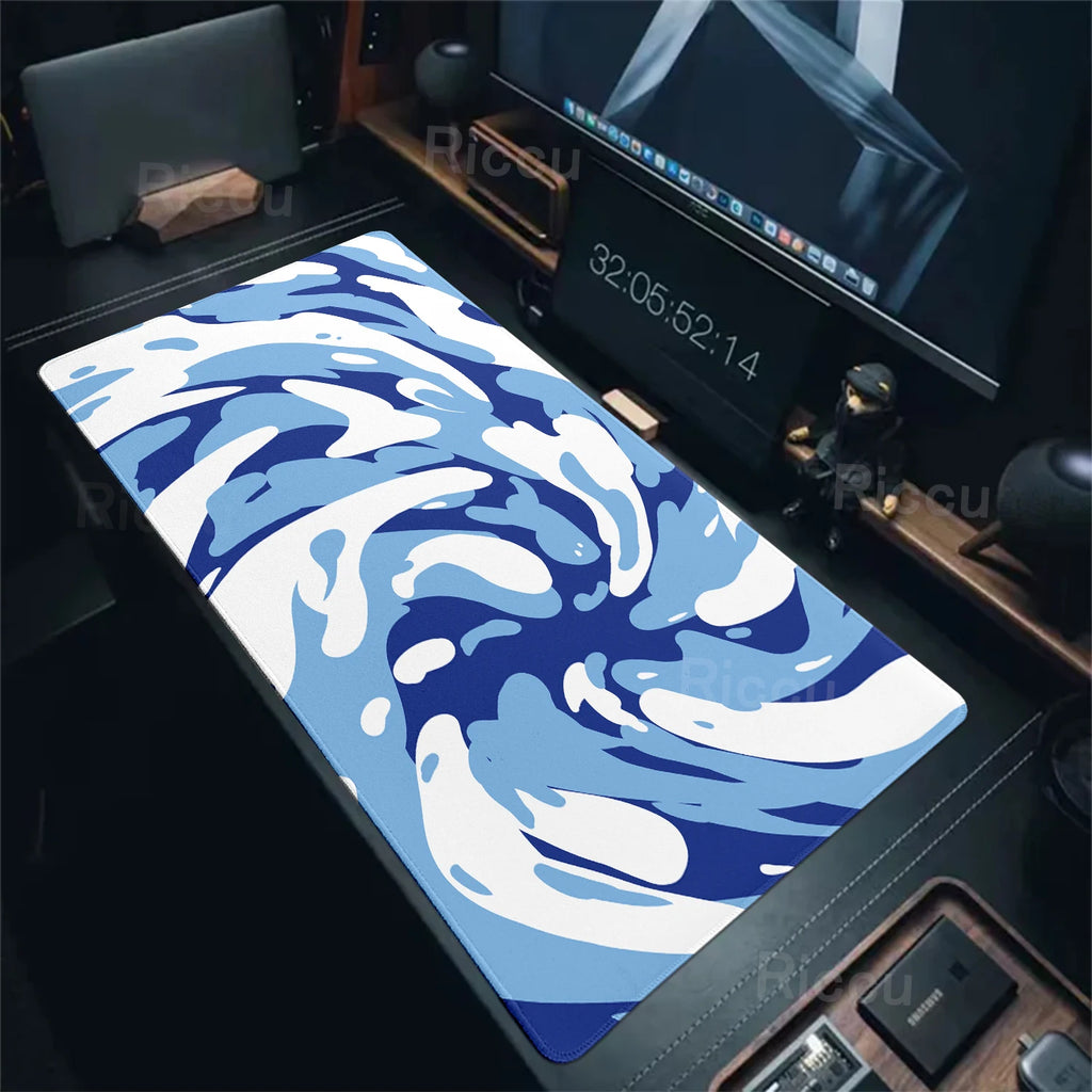 Blue and white camouflage mouse pad on a desk with computer equipment.