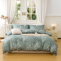 Sage green bedding set with soft botanical print styled in a bright minimalist bedroom