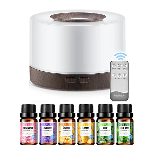White and wooden diffuser with remote control and essential oil bottles on a white background