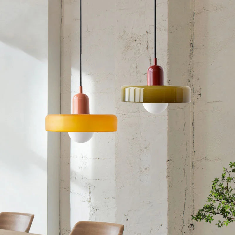 Two pendant lights hanging from the ceiling with a neutral background.