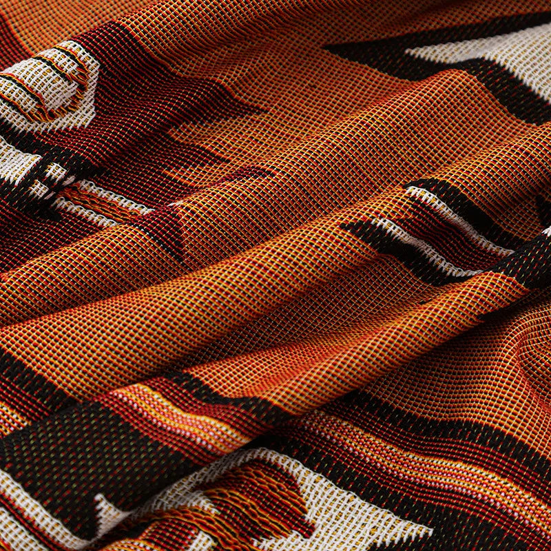 Close-up of a patterned fabric with orange, brown, and beige colours.