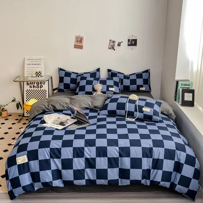 Navy and slate blue checkerboard duvet cover set with matching pillowcases dressed on a double bed in a modern styled bedroom