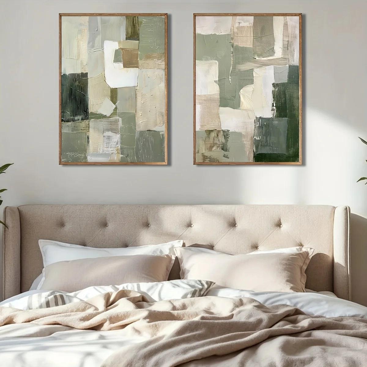 Two abstract art pieces above a bed in a bedroom setting.